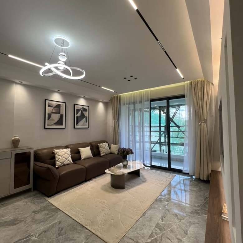 Lounge with balcony access at Golfscape Residences apartments in Kilimani
