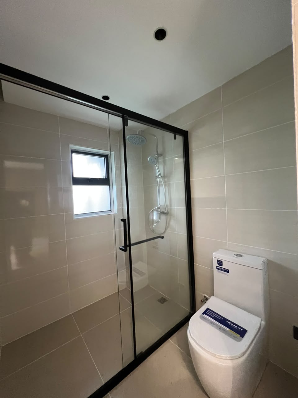 Bathroom with glass shower at Golfscape Residences apartments in Kilimani