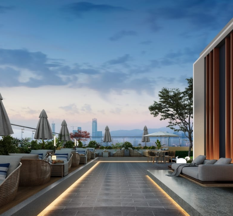 Golden Mansion Apartments rooftop lounge featuring outdoor sofas, sun loungers, parasols, landscaped plants, decorative lighting, and distant city views.