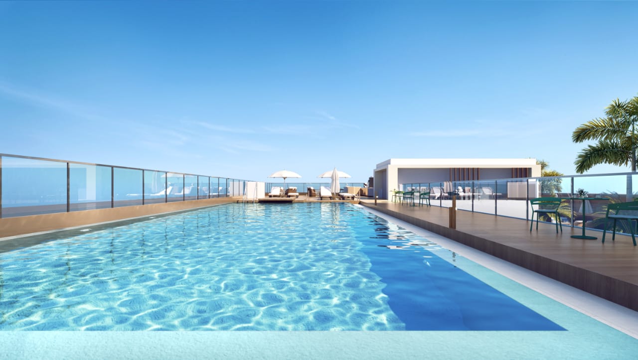 Golden Mansion Apartments rooftop swimming pool rendering featuring a large outdoor pool, glass safety railings, poolside loungers, parasols, and panoramic views.
