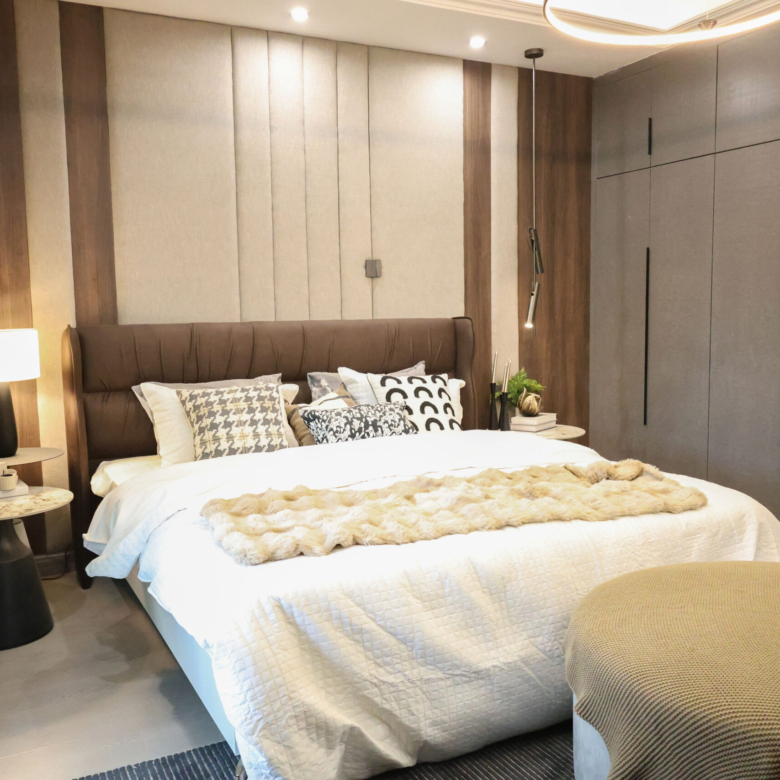 Modern bedroom with a large upholstered bed and fitted wardrobes at Venus Oak Residency in Kileleshwa.