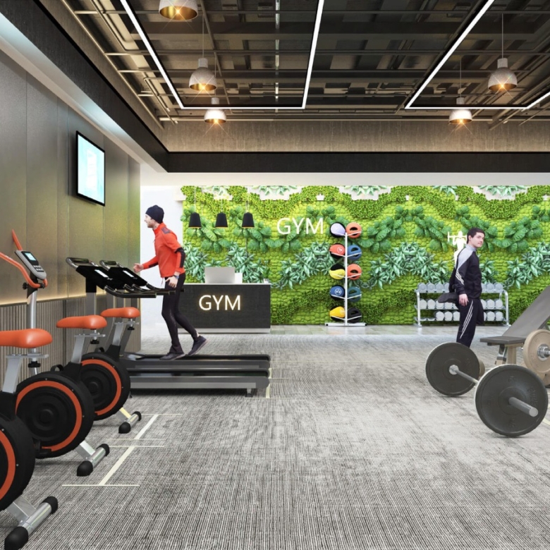 Black Olive Residency fully equipped gym featuring exercise bikes, treadmills, free weights, fitness benches and modern workout facilities.