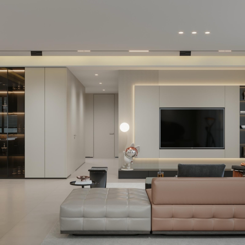 Brookside One Residency spacious living room featuring modern sectional sofa, stylish TV wall, contemporary furniture and large windows.