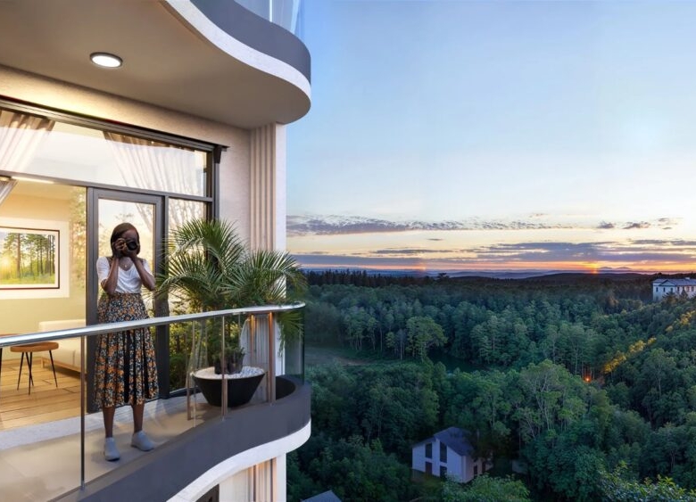 Oak Breeze Residency apartment balcony overlooking greenery at sunset