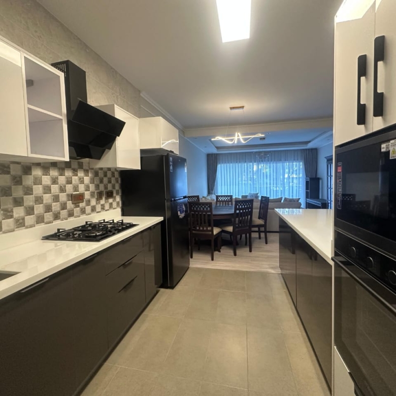 Open-plan kitchen and living area at Pearl Rivers Riverside