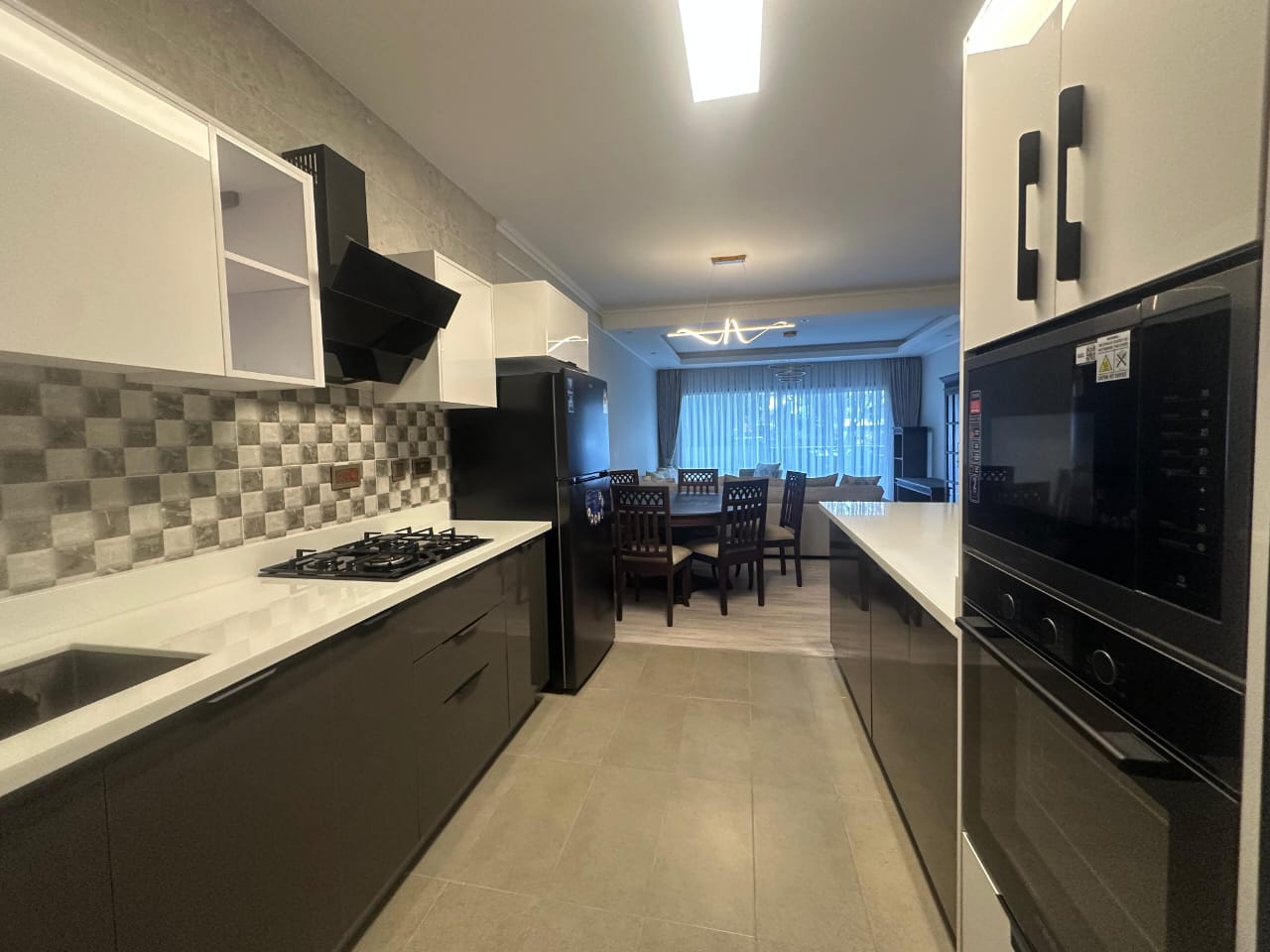 Open-plan kitchen and living area at Pearl Rivers Riverside