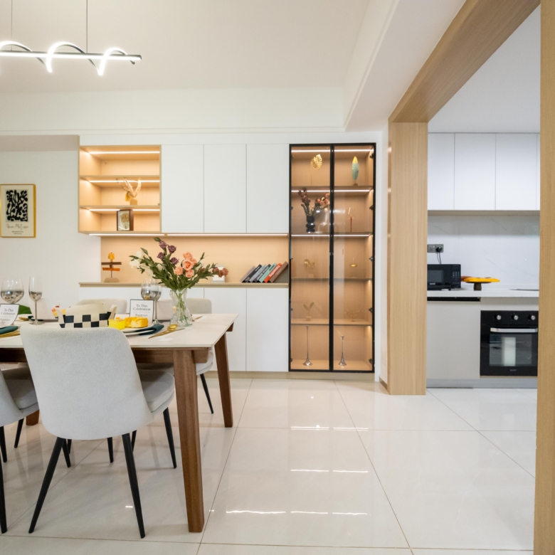 Rhapta One Residency elegant dining room with four-seater table, illuminated shelving, glass-fronted display cabinet, and kitchen access.