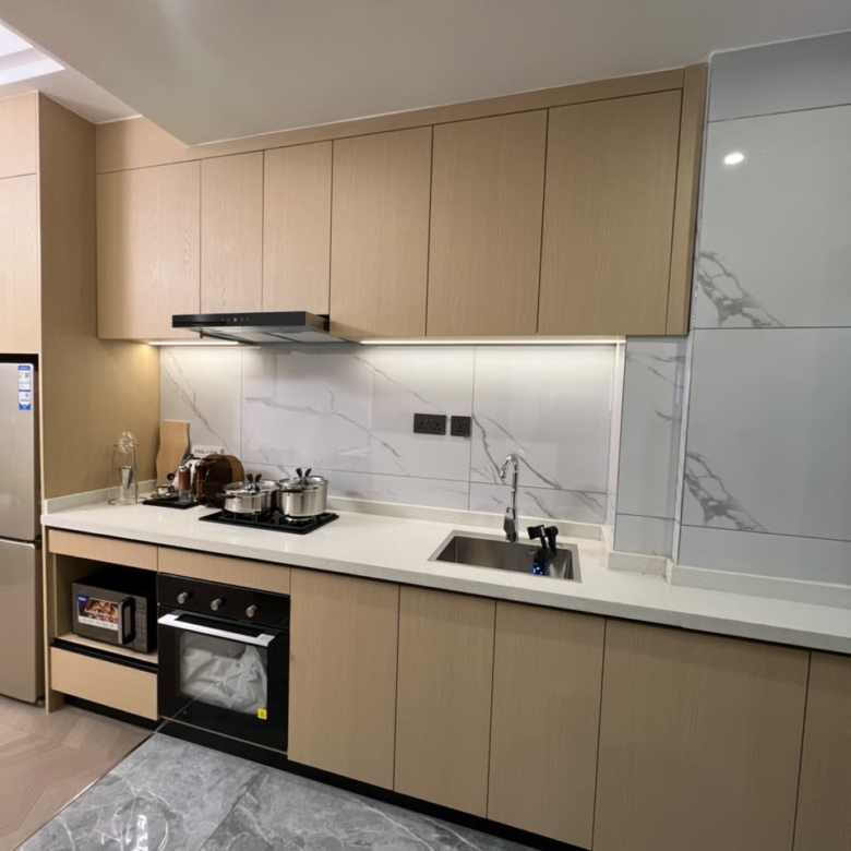 Diplomat Residences on Peponi Road Westlands Nairobi kitchen with fitted cabinets, oven, sink and marble backsplash