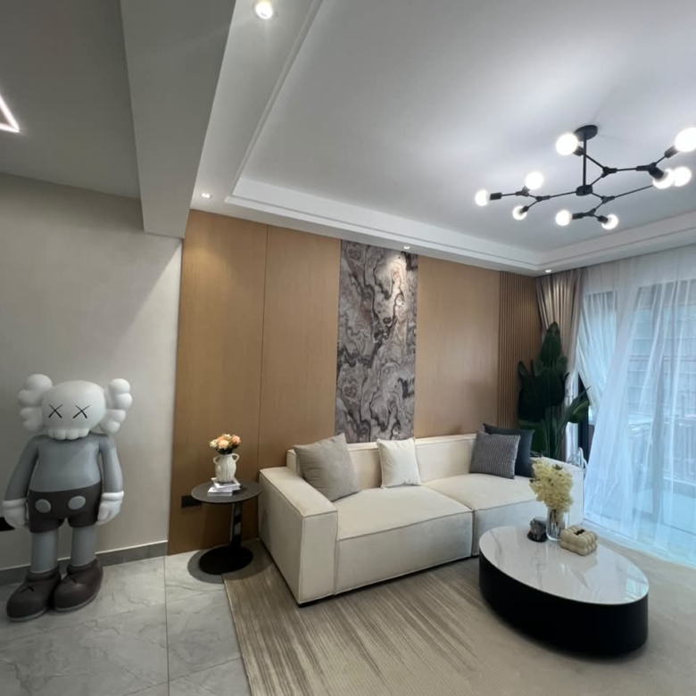 Diplomat Residences on Peponi Road Westlands Nairobi living room with modern sofa, feature wall and balcony curtains