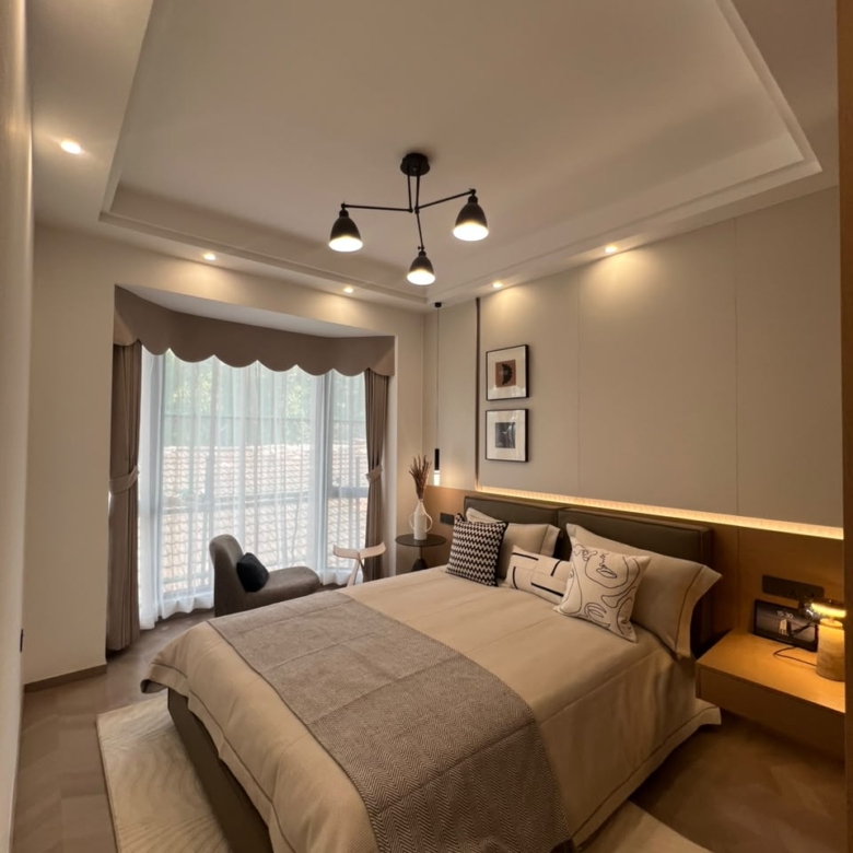 Diplomat Residences on Peponi Road Westlands Nairobi master bedroom with large bed, window and warm lighting