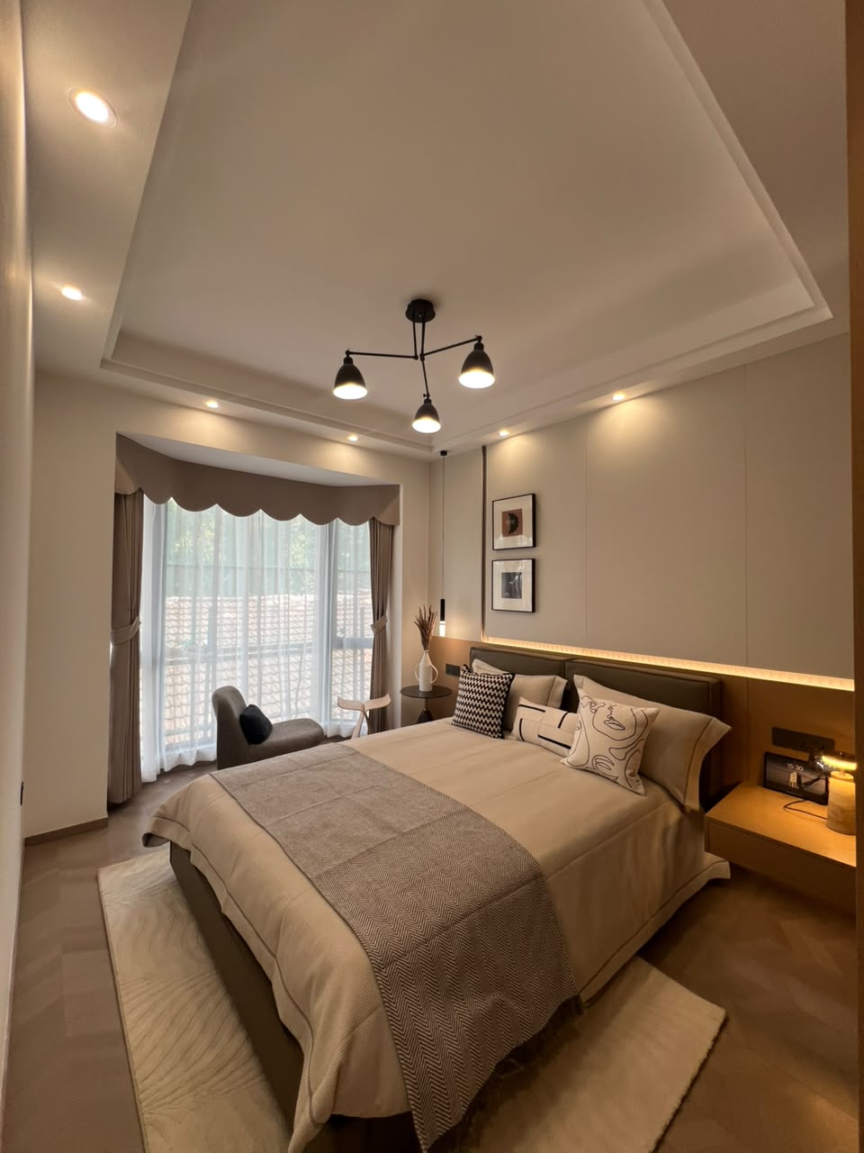 Diplomat Residences on Peponi Road Westlands Nairobi master bedroom with large bed, window and warm lighting
