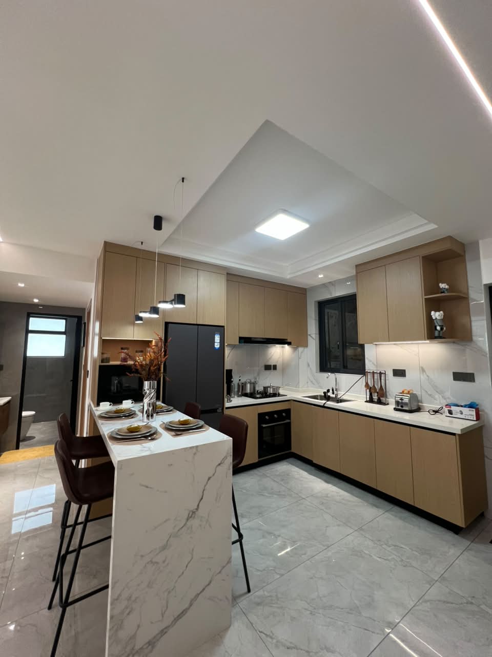 Diplomat Residences on Peponi Road Westlands Nairobi modern kitchen with island, fitted cabinets and marble countertops