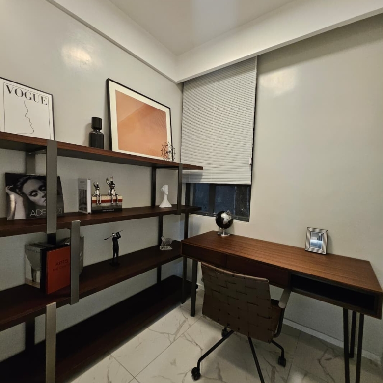 Furnished home office with wooden desk and shelving at ILU Green Homes Kilimani