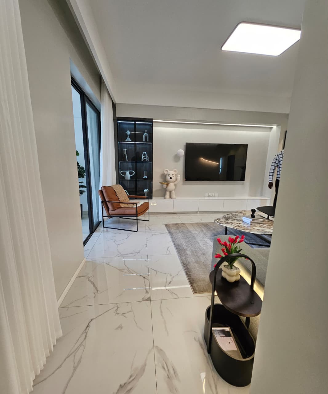 Entrance view of a modern living room with TV wall at ILU Green Homes Kilimani