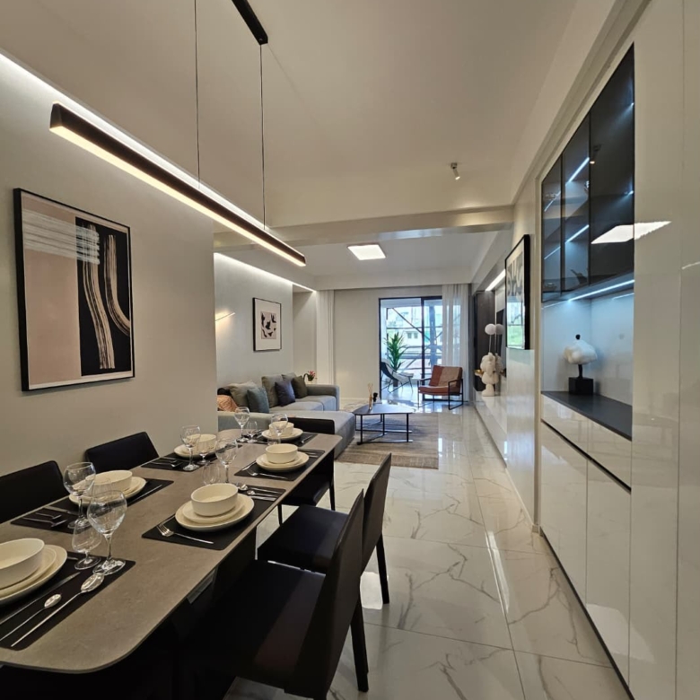 Open-plan dining and living room with modern lighting at ILU Green Homes