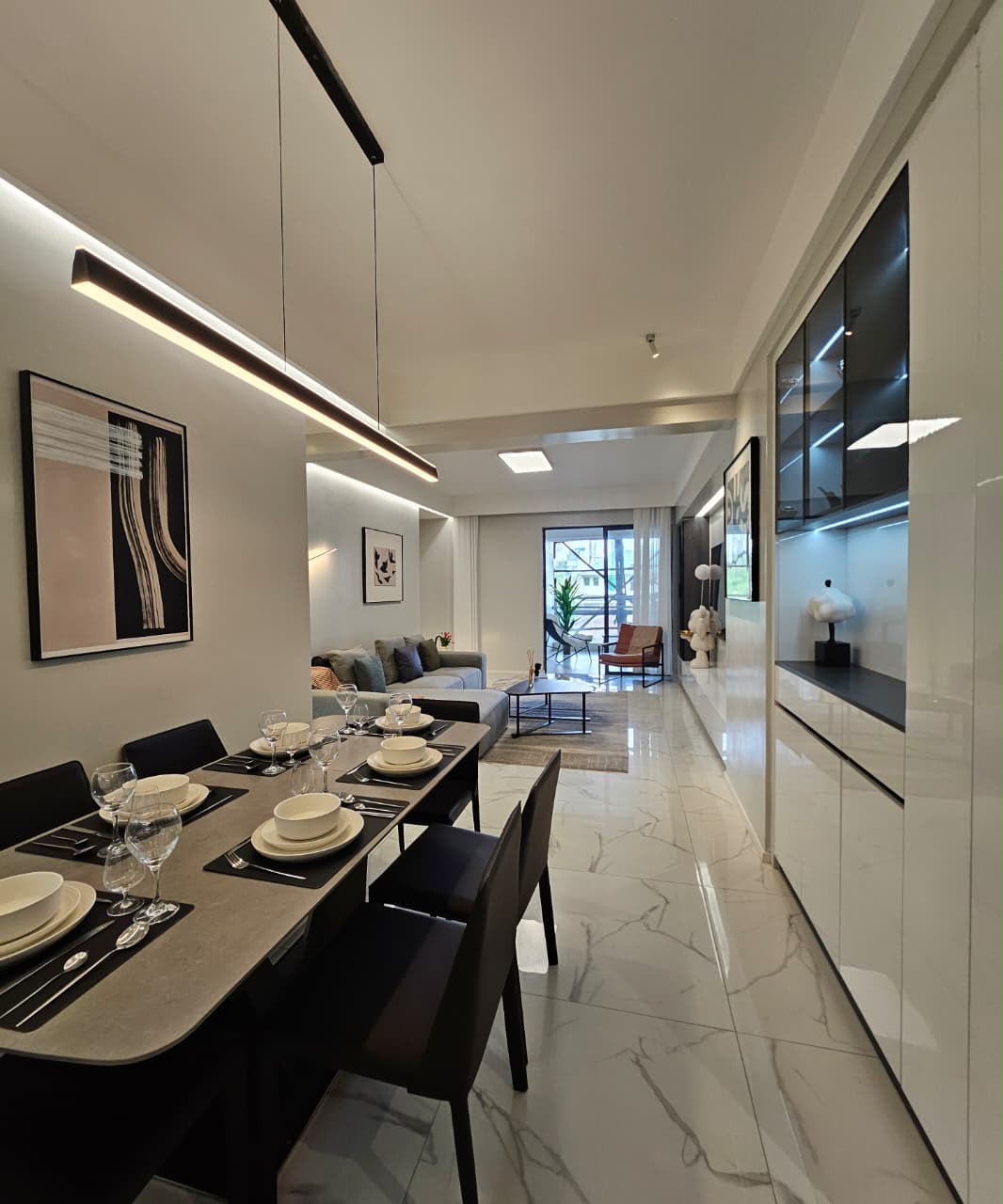 Open-plan dining and living room with modern lighting at ILU Green Homes
