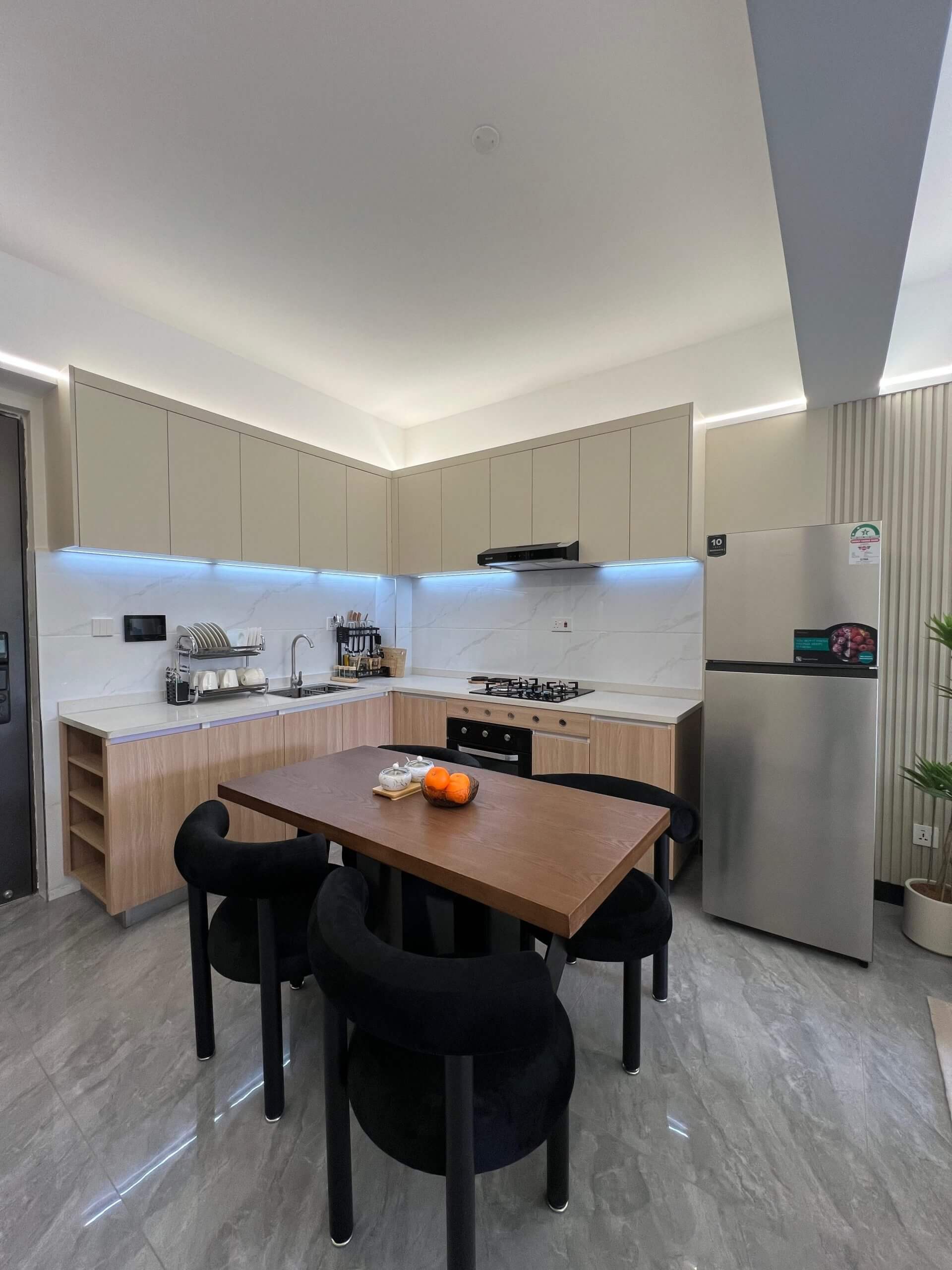 Open plan kitchen and dining area at Ten50 Residences featuring modern cabinetry.