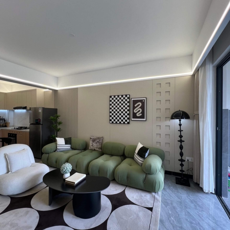 Modern living room interior at Ten50 Residences Kilimani with green sofa.