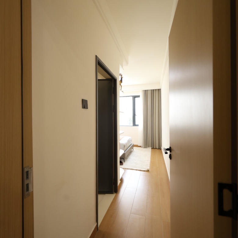 Interior corridor leading to a bedroom in a Luster Arbor Residency apartment