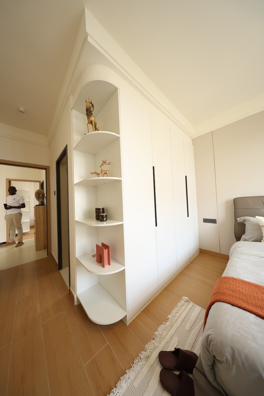 Bedroom with fitted wardrobes and display shelving at Luster Arbor Residency