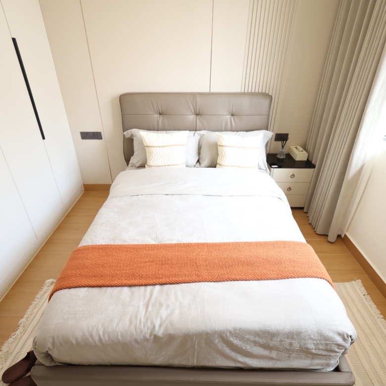 Bright furnished bedroom with fitted wardrobe in a Luster Arbor Residency apartment