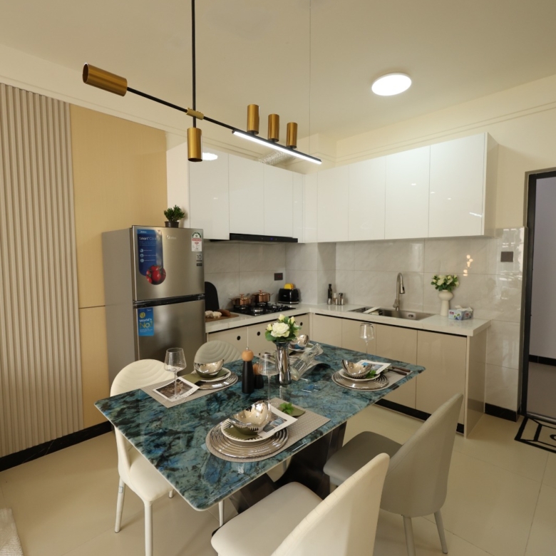 Dining area beside a fitted kitchen in a Luster Arbor Residency show apartment