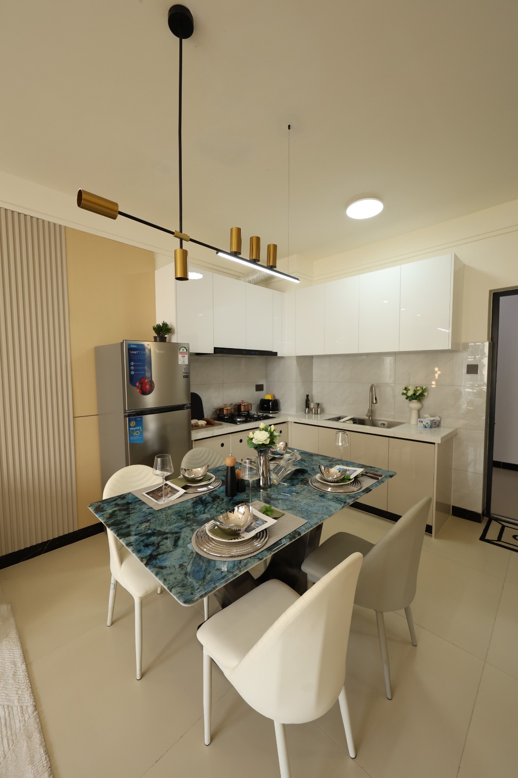 Dining area beside a fitted kitchen in a Luster Arbor Residency show apartment