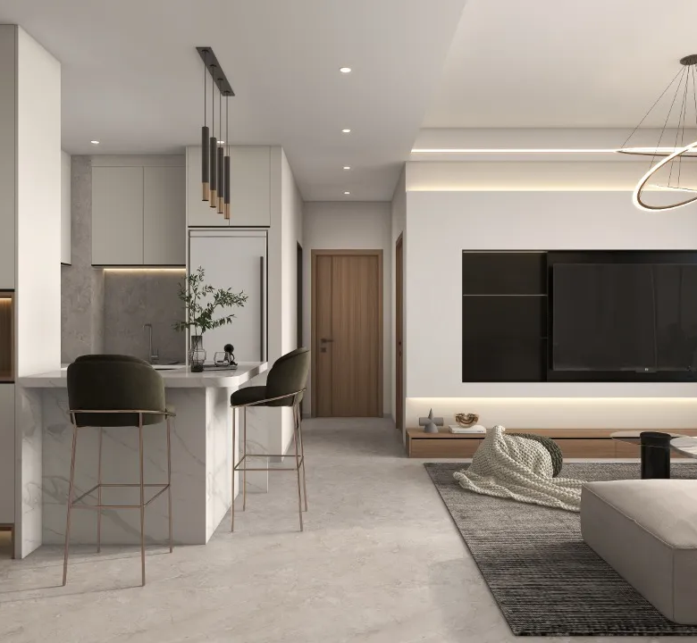 Riara One Residency open-plan living room with cream sectional sofa, breakfast counter, modern lighting, and fitted kitchen.