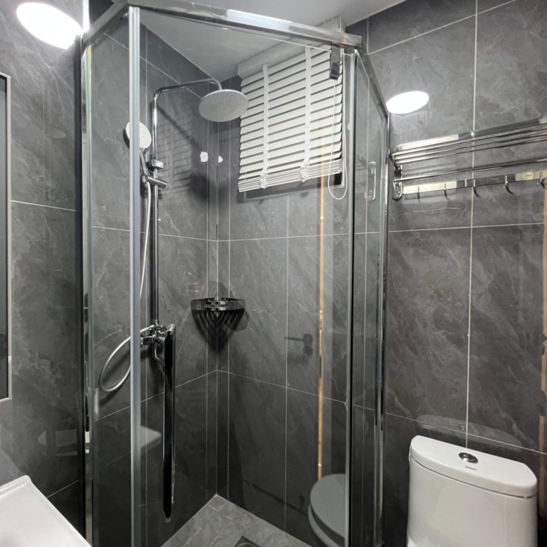 Modern bathroom vanity and shower cubicle at Ten50 Residences.