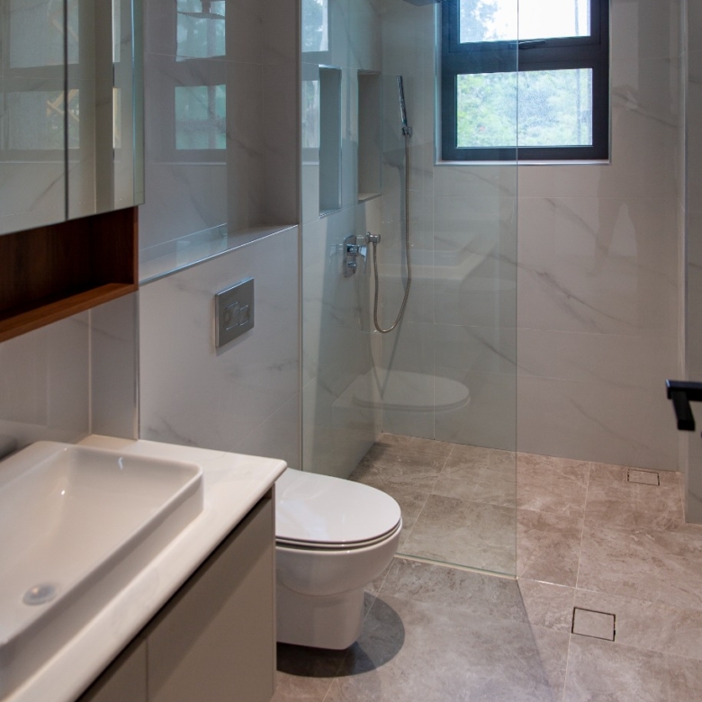 Modern bathroom with walk-in glass shower at Sunset Park Apartments