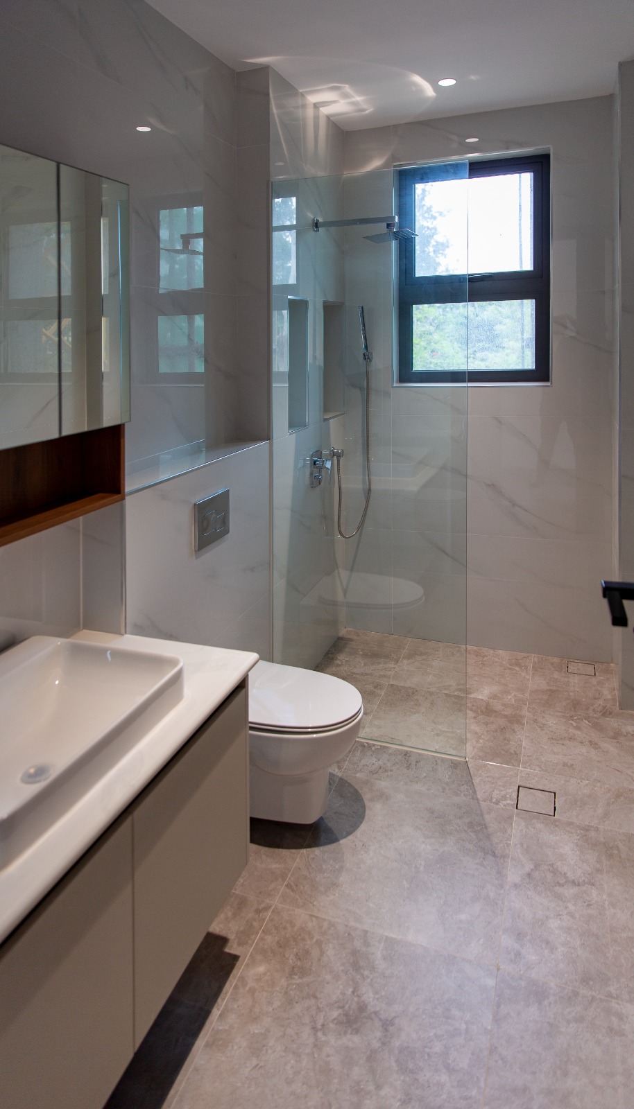 Modern bathroom with walk-in glass shower at Sunset Park Apartments