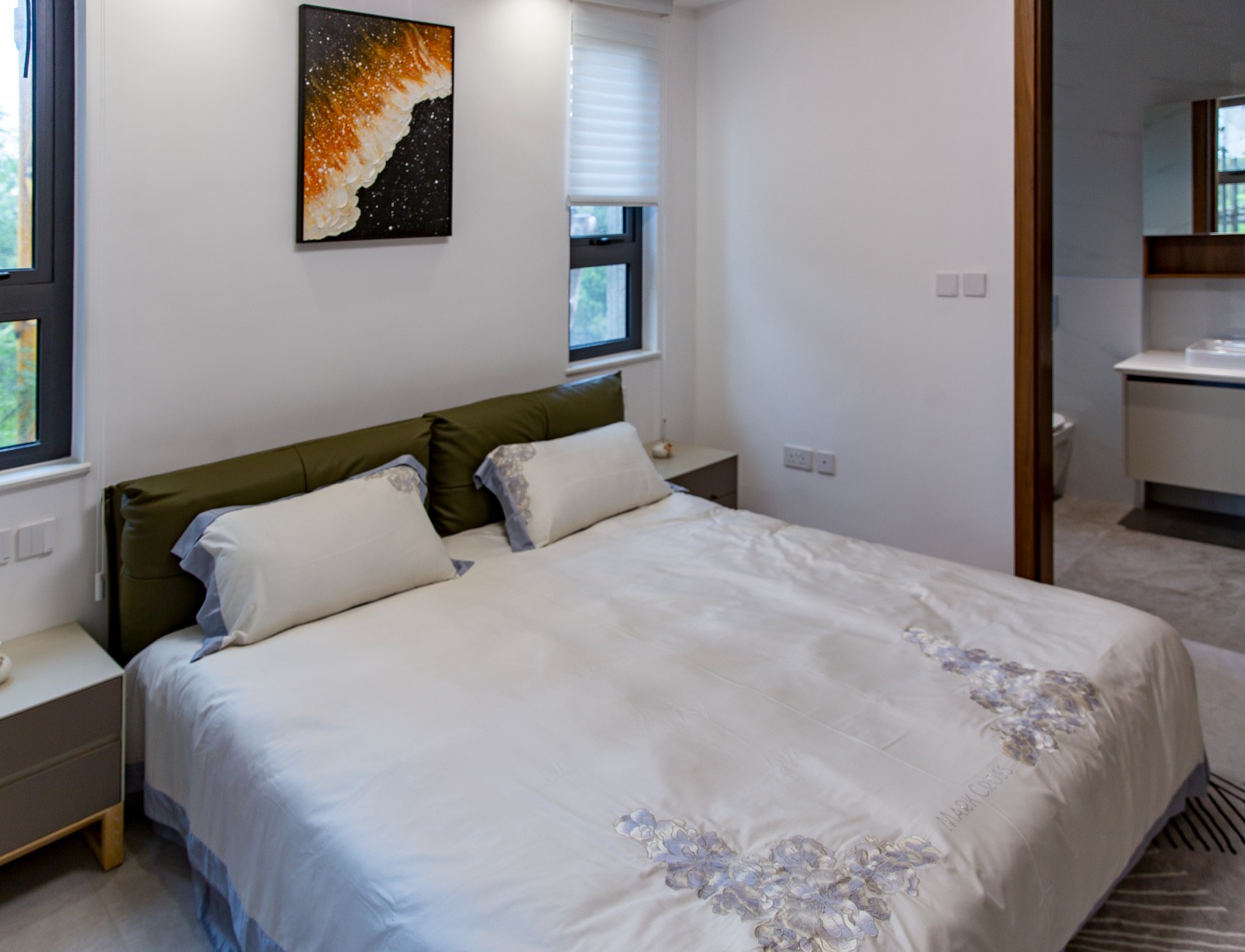 Furnished bedroom with ensuite bathroom at Sunset Park Apartments