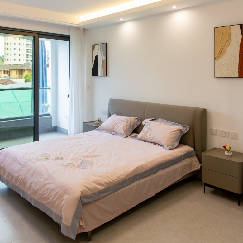 Spacious bedroom with private balcony at Sunset Park Apartments