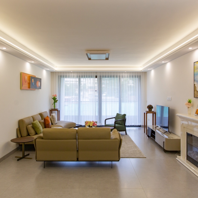 Bright living room with large windows at Sunset Park Apartments