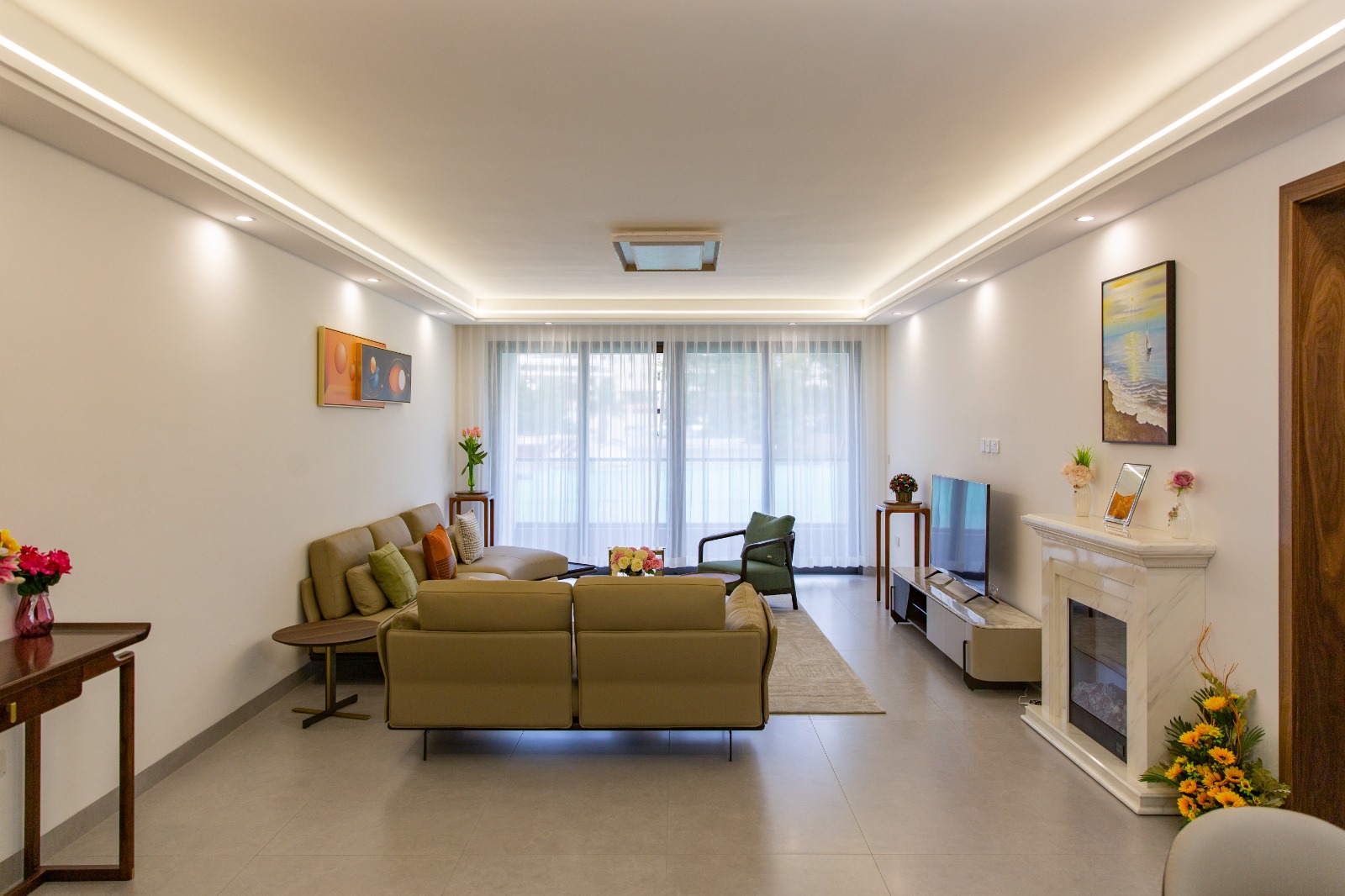 Bright living room with large windows at Sunset Park Apartments