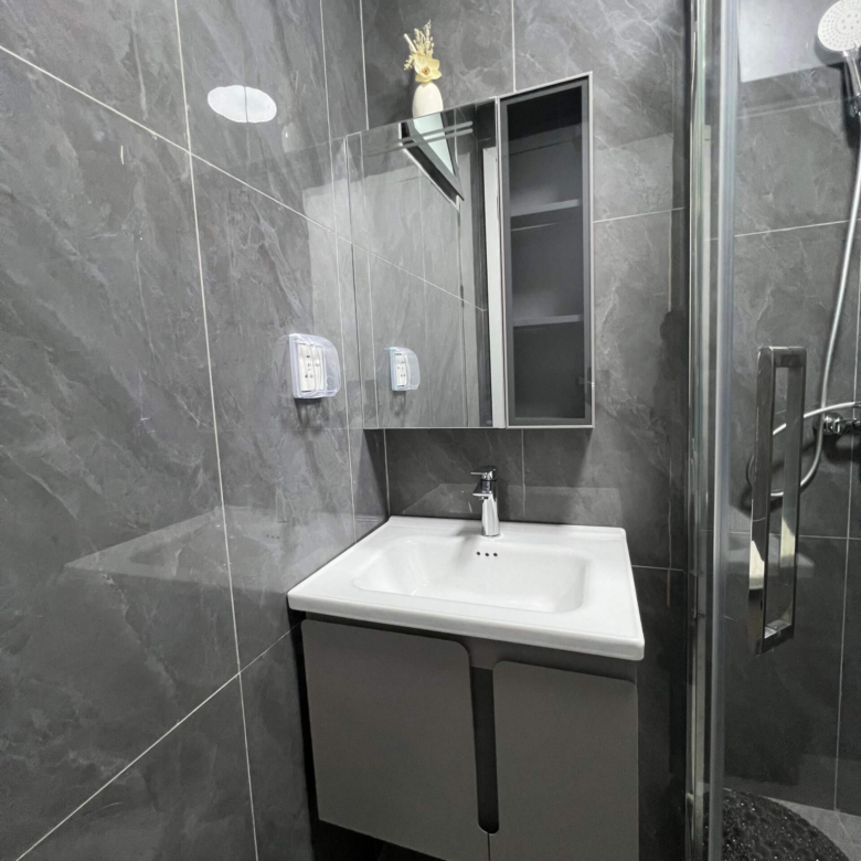 Modern bathroom vanity and shower cubicle at Ten50 Residences.
