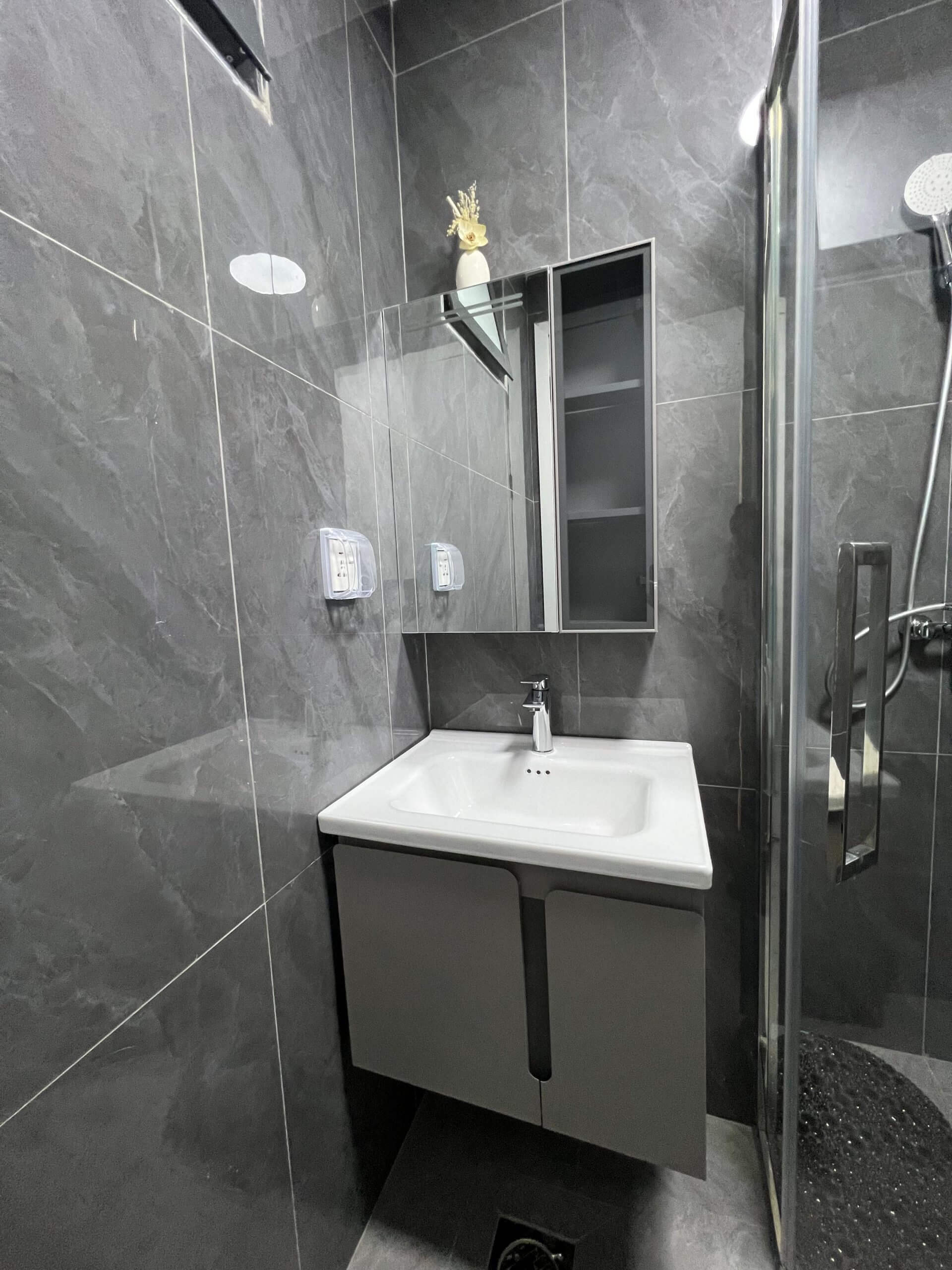 Modern bathroom vanity and shower cubicle at Ten50 Residences.