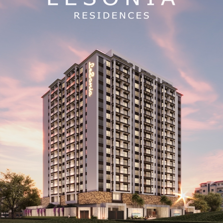 Lesonia Residence modern high-rise apartment exterior with glass balconies, contemporary architecture, and illuminated building facade.