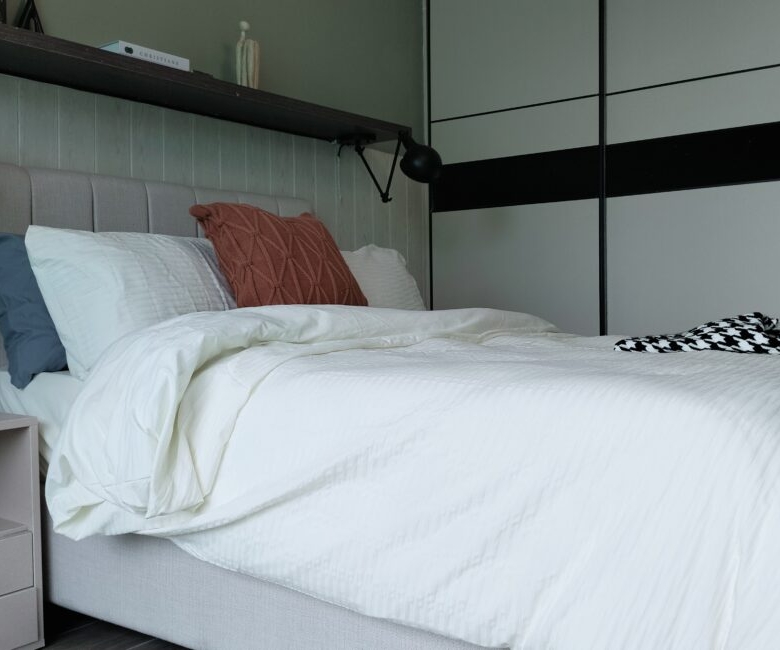 Citi Rise Residency in Westlands bedroom with white bedding, fitted wardrobe and modern bedside lighting