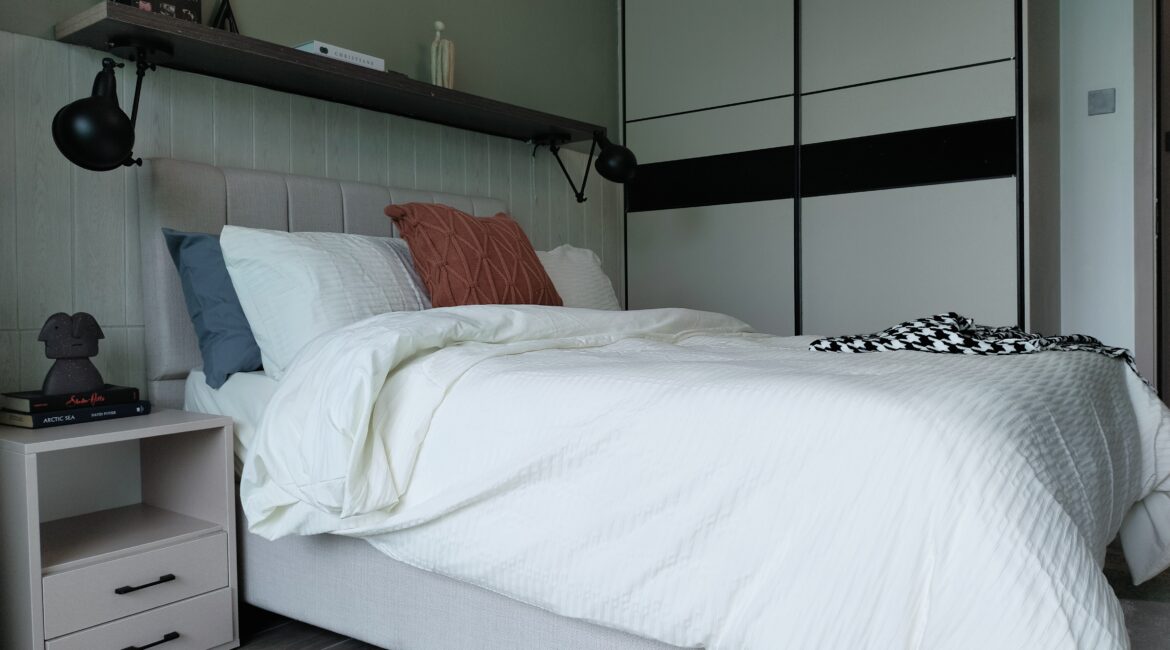 Citi Rise Residency in Westlands bedroom with white bedding, fitted wardrobe and modern bedside lighting