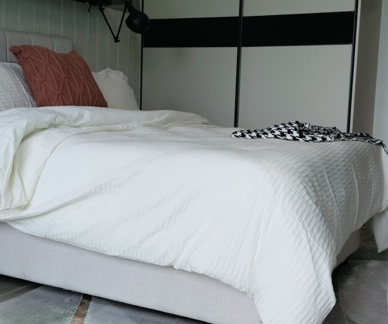 Citi Rise Residency in Westlands bedroom with upholstered headboard, floating shelf and twin wall lamps