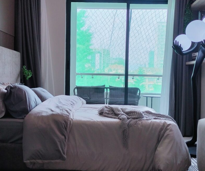 Citi Rise Residency in Westlands bedroom with balcony doors, soft bedding and decorative floor lamp