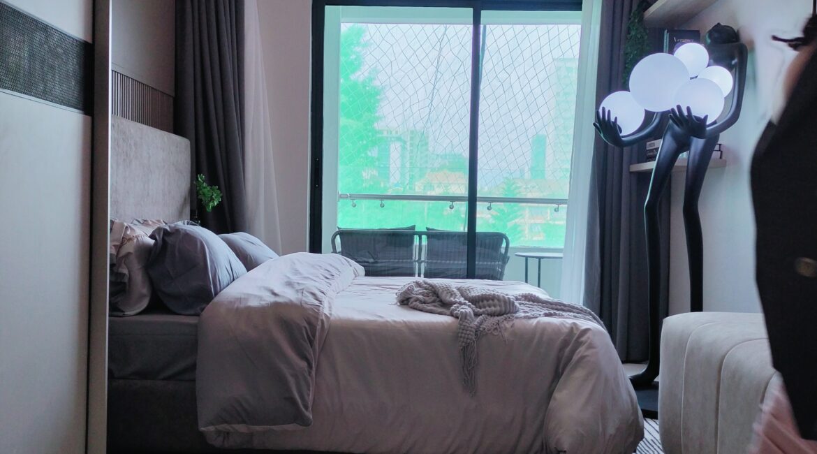 Citi Rise Residency in Westlands bedroom with balcony doors, soft bedding and decorative floor lamp
