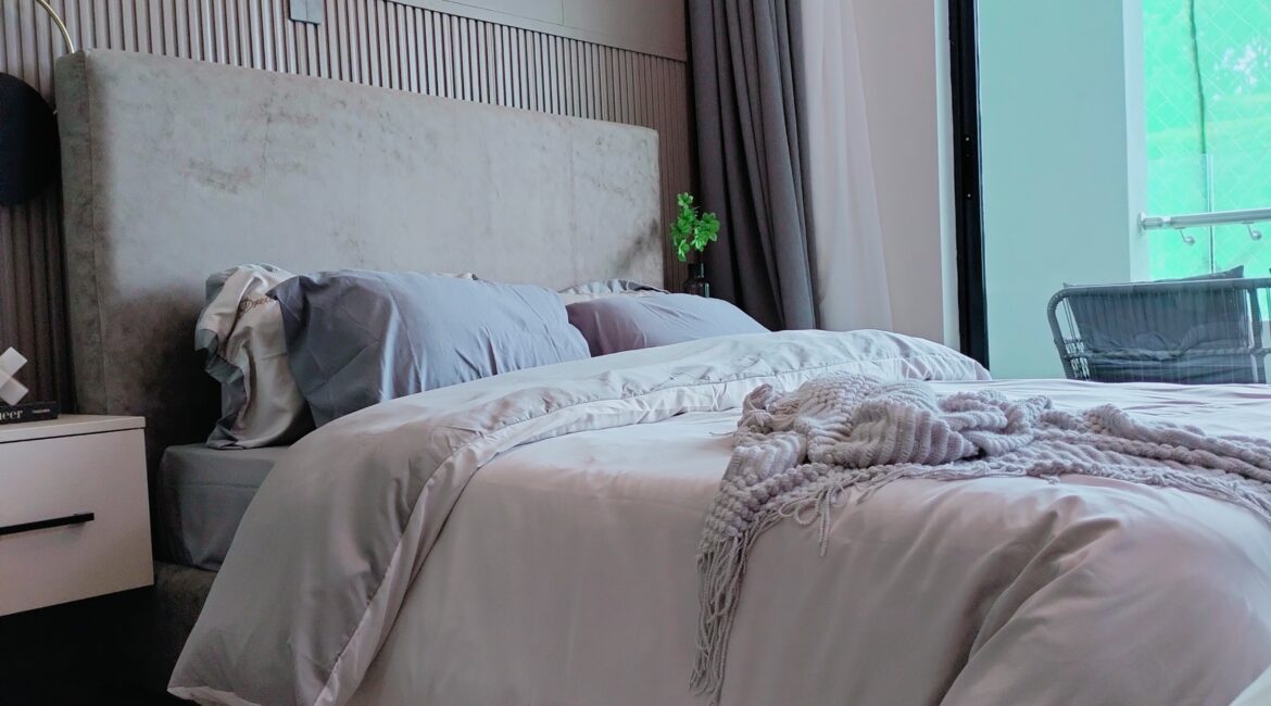Citi Rise Residency in Westlands furnished bedroom with upholstered headboard, soft bedding and balcony access