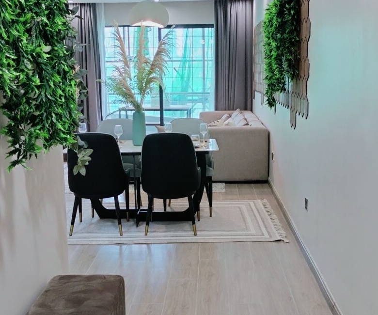 Citi Rise Residency in Westlands dining area with black chairs, indoor greenery and living room beyond