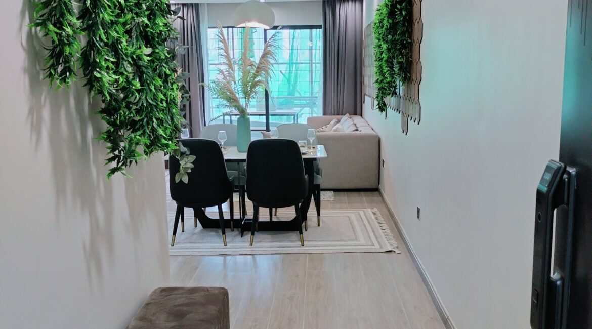 Citi Rise Residency in Westlands dining area with black chairs, indoor greenery and living room beyond