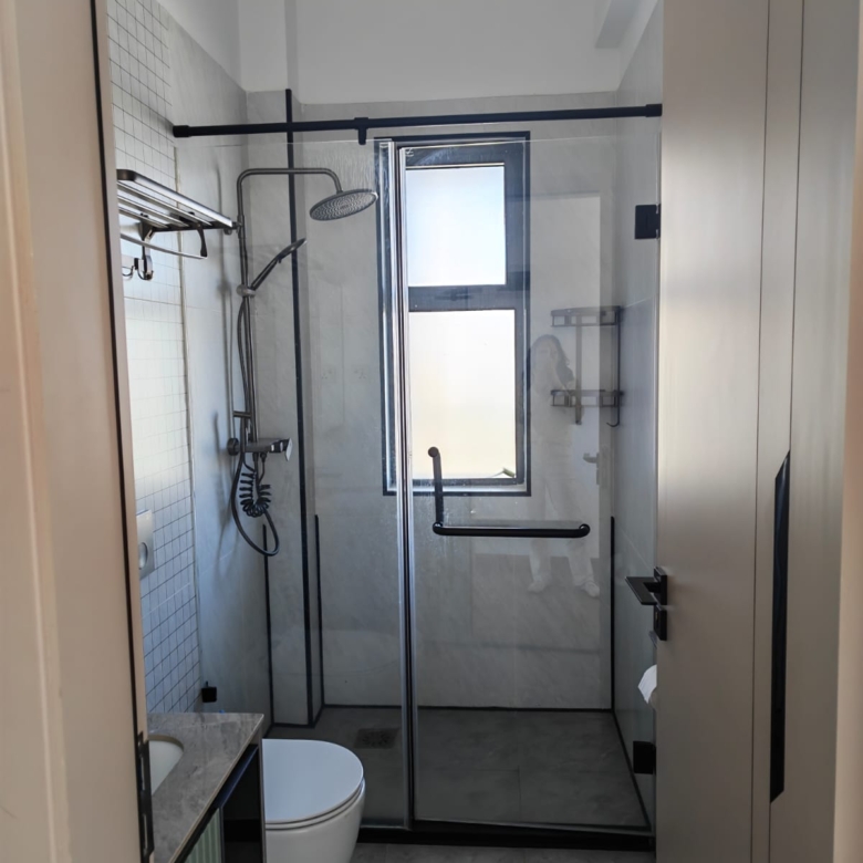 Clean, tiled bathroom interior featuring high-end sanitary ware and chrome fixtures.