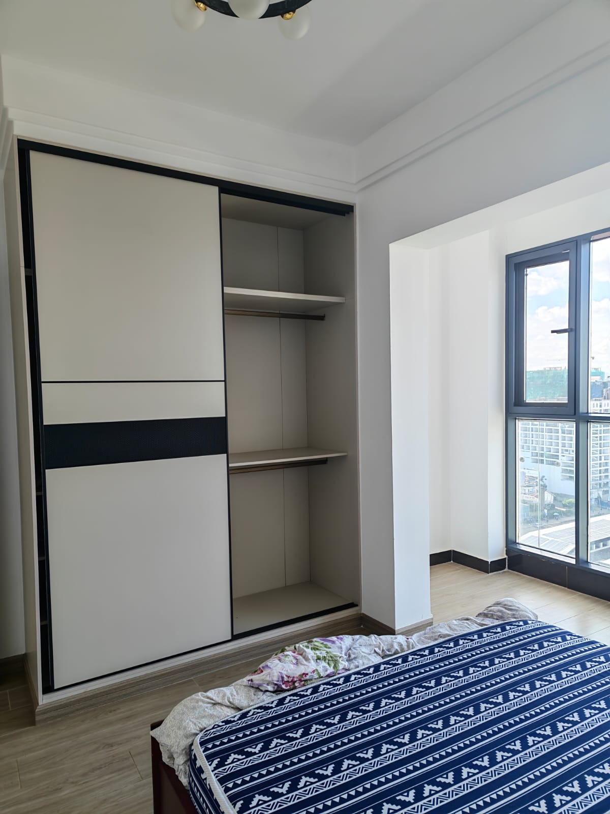 Custom-built floor-to-ceiling wooden storage cabinets in a 56sqm Kilimani apartment.