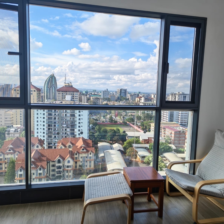 Floor-to-ceiling soundproof window in a Kilimani apartment allowing for maximum natural light.