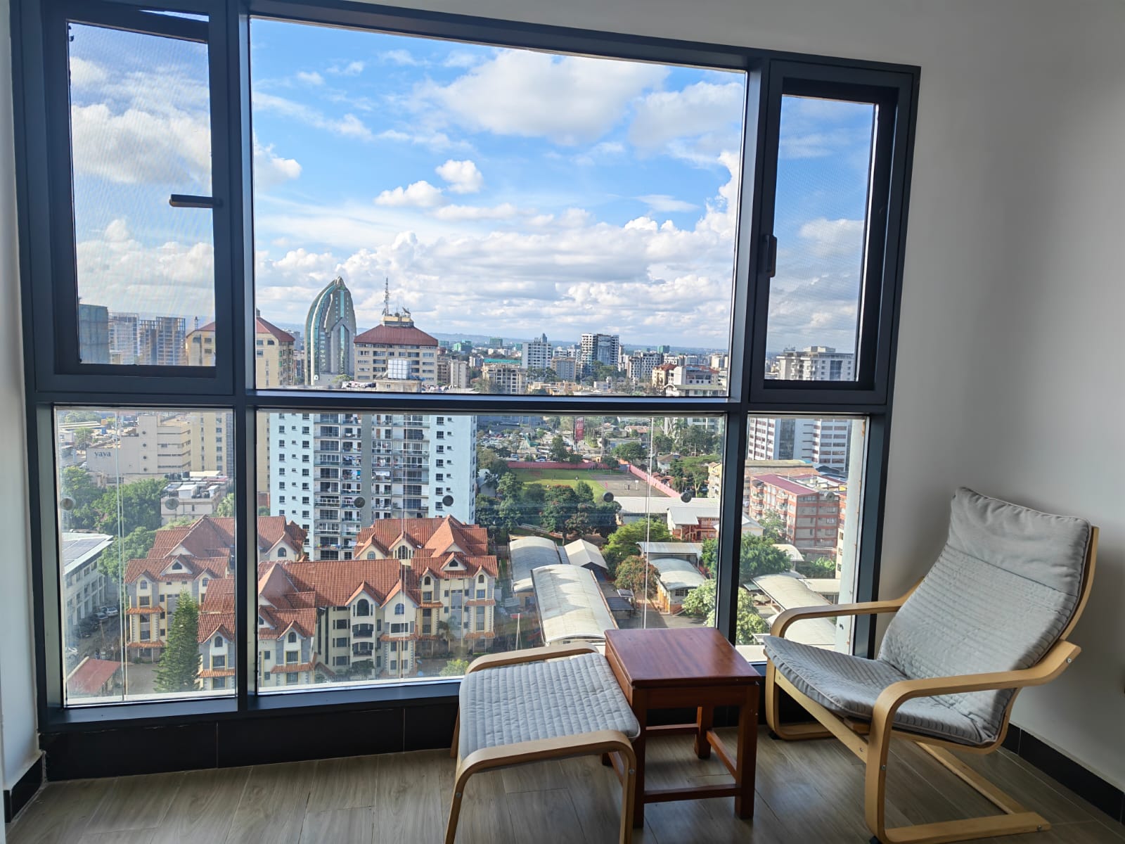 Floor-to-ceiling soundproof window in a Kilimani apartment allowing for maximum natural light.